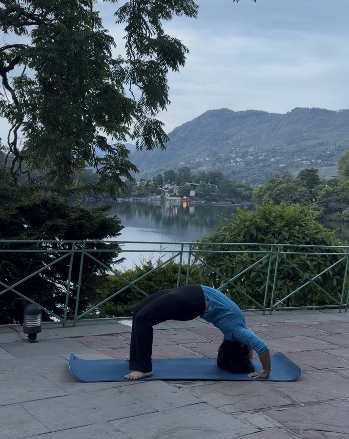 Minal practising chakrasana by Nainital lake